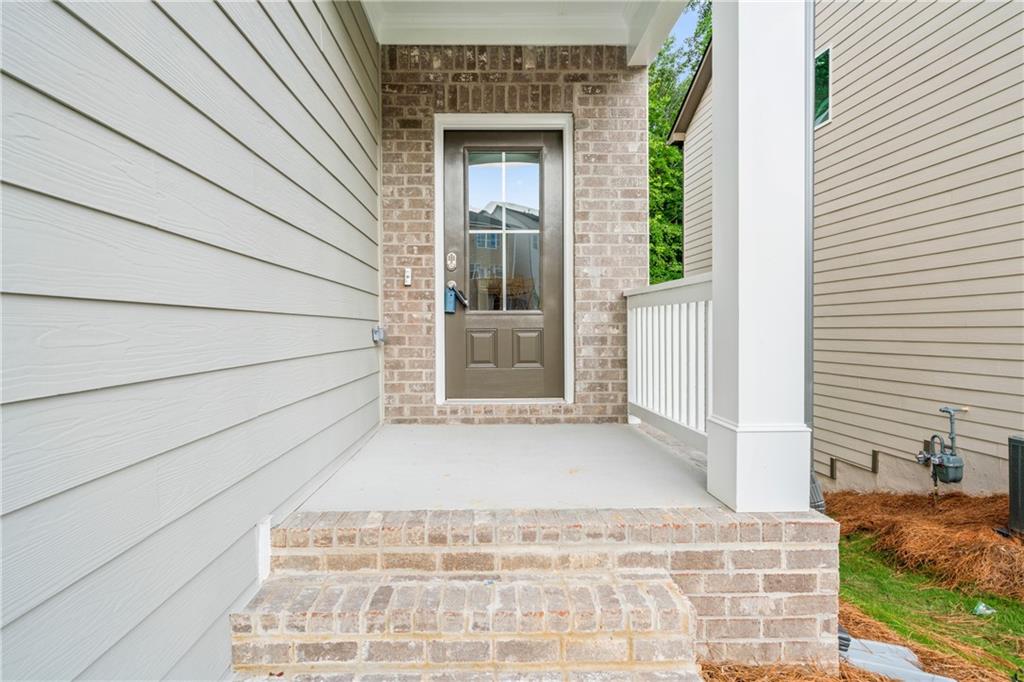 32 Station Overlook Way Auburn, GA 30011 - Photo 2 of 38 a white house with a outdoor space