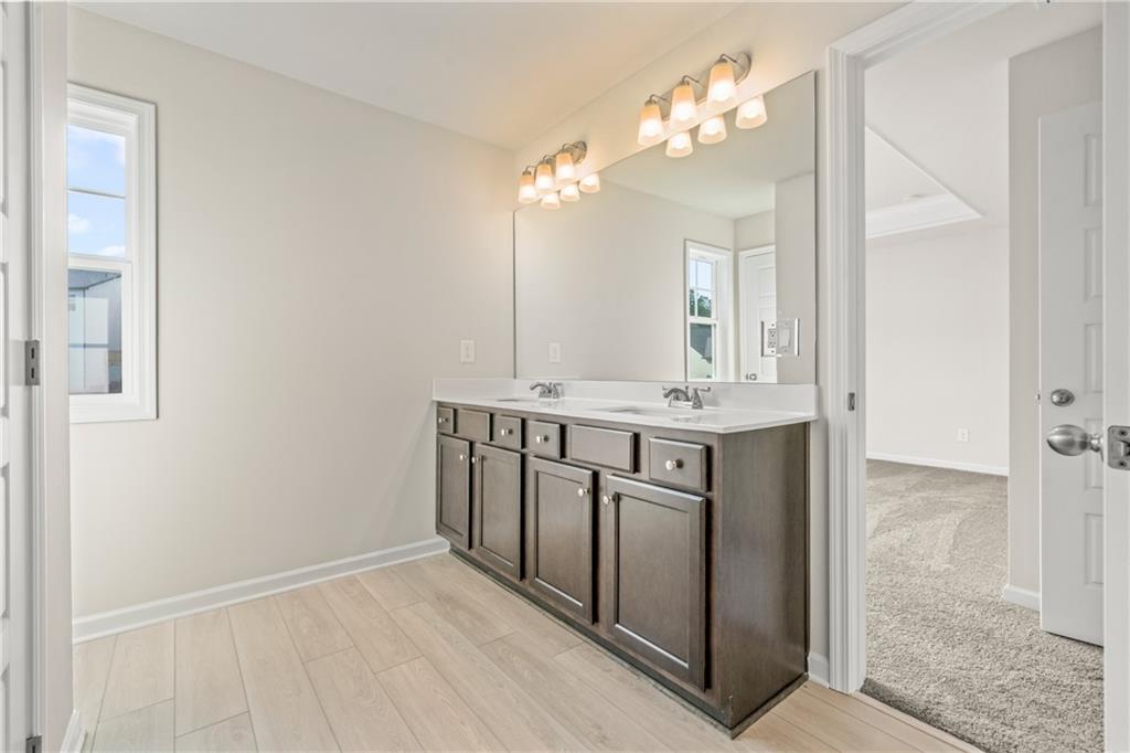 32 Station Overlook Way Auburn, GA 30011 - Photo 28 of 38 a bathroom with a sink vanity and a mirror