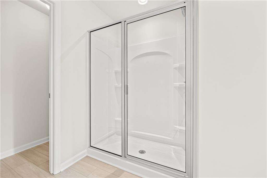 32 Station Overlook Way Auburn, GA 30011 - Photo 29 of 38 a bathroom with a glass shower door