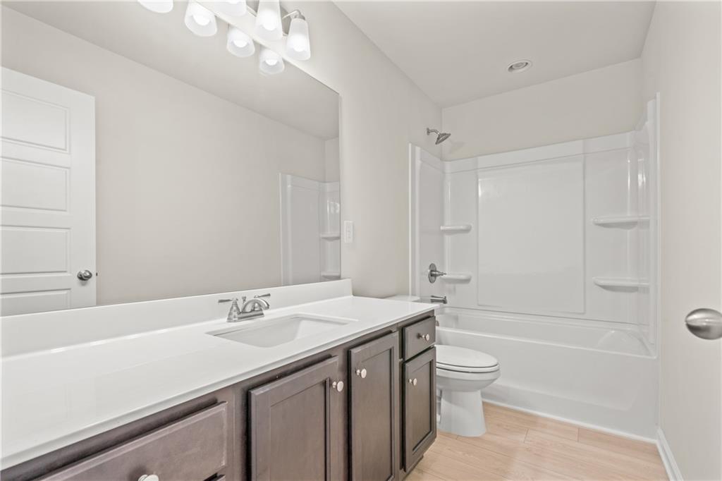 32 Station Overlook Way Auburn, GA 30011 - Photo 32 of 38 a bathroom with a sink a toilet and shower