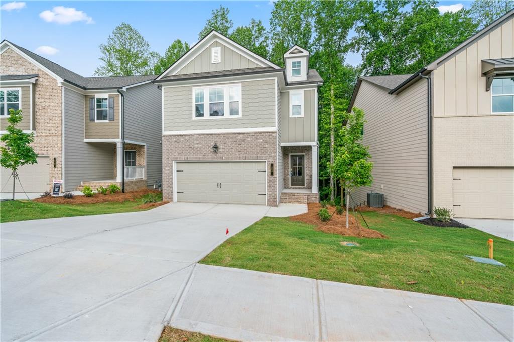 32 Station Overlook Way Auburn, GA 30011 - Photo 35 of 38 a front view of a house with a yard and garage
