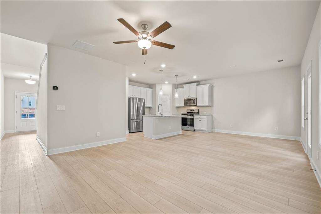 32 Station Overlook Way Auburn, GA 30011 - Photo 6 of 38 a view of a kitchen with a sink and wooden floor