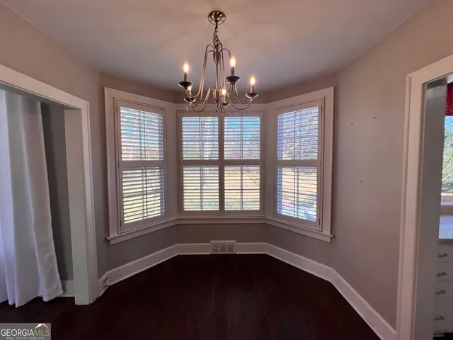 a view of an entryway with wooden floor and stairs