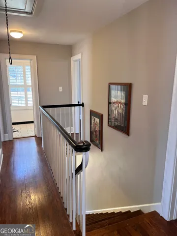 a view of a hallway view with wooden floor and staircase