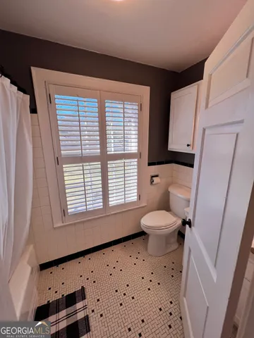 a view of flowing water with large building in the background