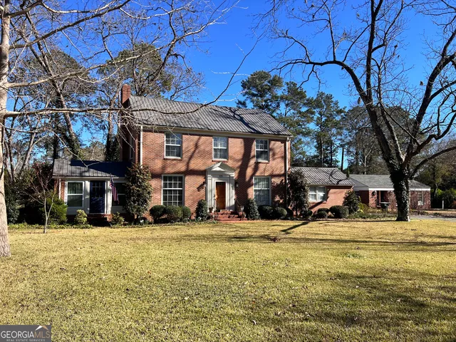 a view of a house with pool and sitting area
