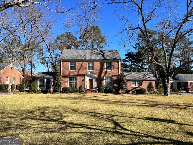 a view of a house with snow on the side of the road