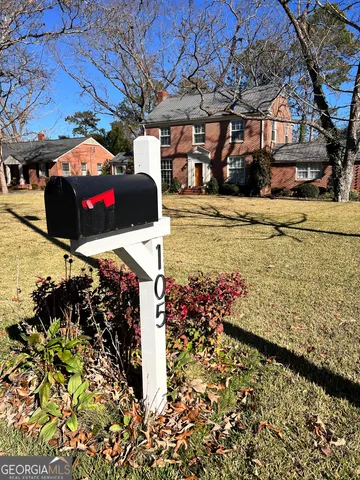 a view of a backyard with large trees