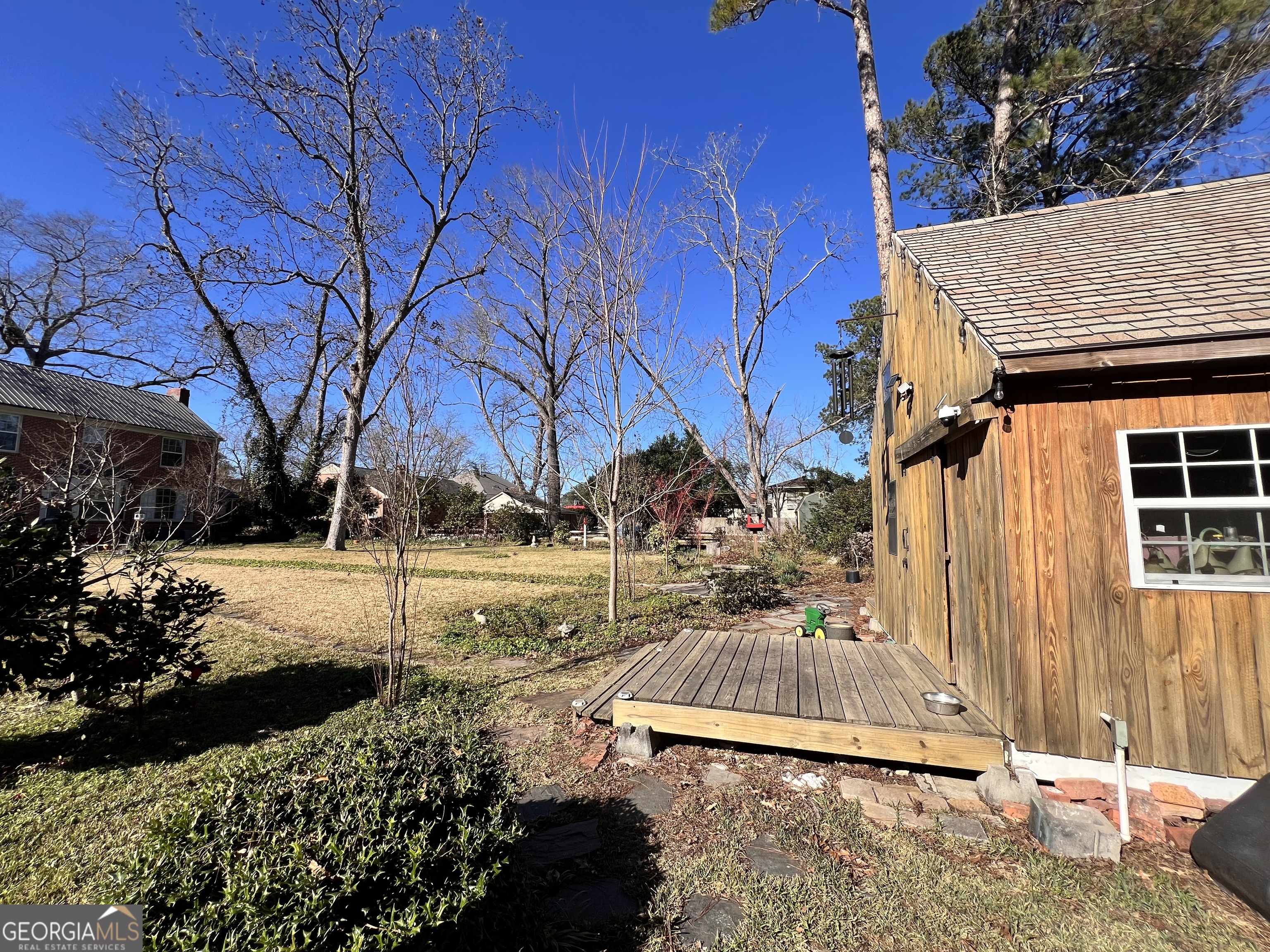 105 Lacross Street Dublin, GA 31021 - Photo 51 of 68 a view of a backyard with large trees