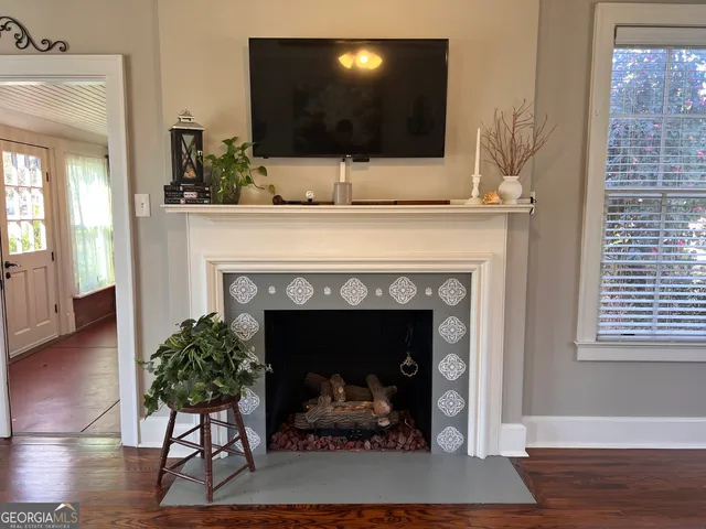 a living room with a fireplace and a flat screen tv