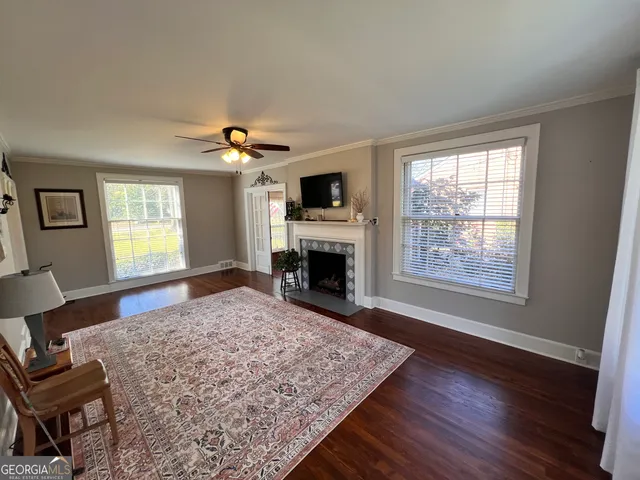 a living room with furniture a fireplace and a flat screen tv