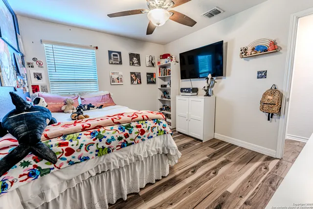 a bedroom with a bed and flat screen tv