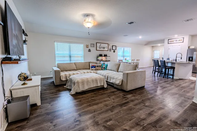 a bedroom with a bed wooden floor and furniture