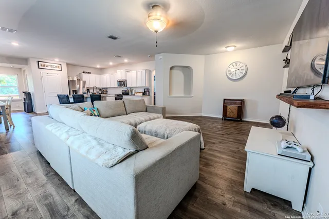 a living room with furniture and a large mirror