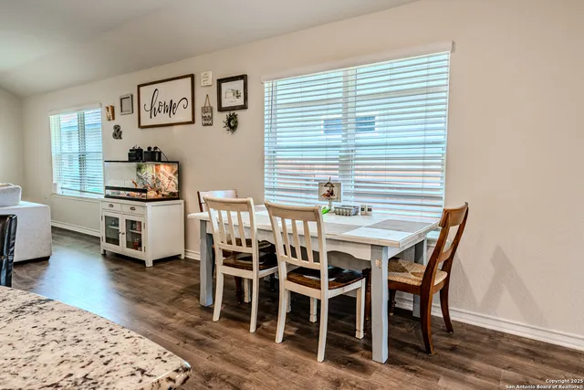 a dining room with furniture and window