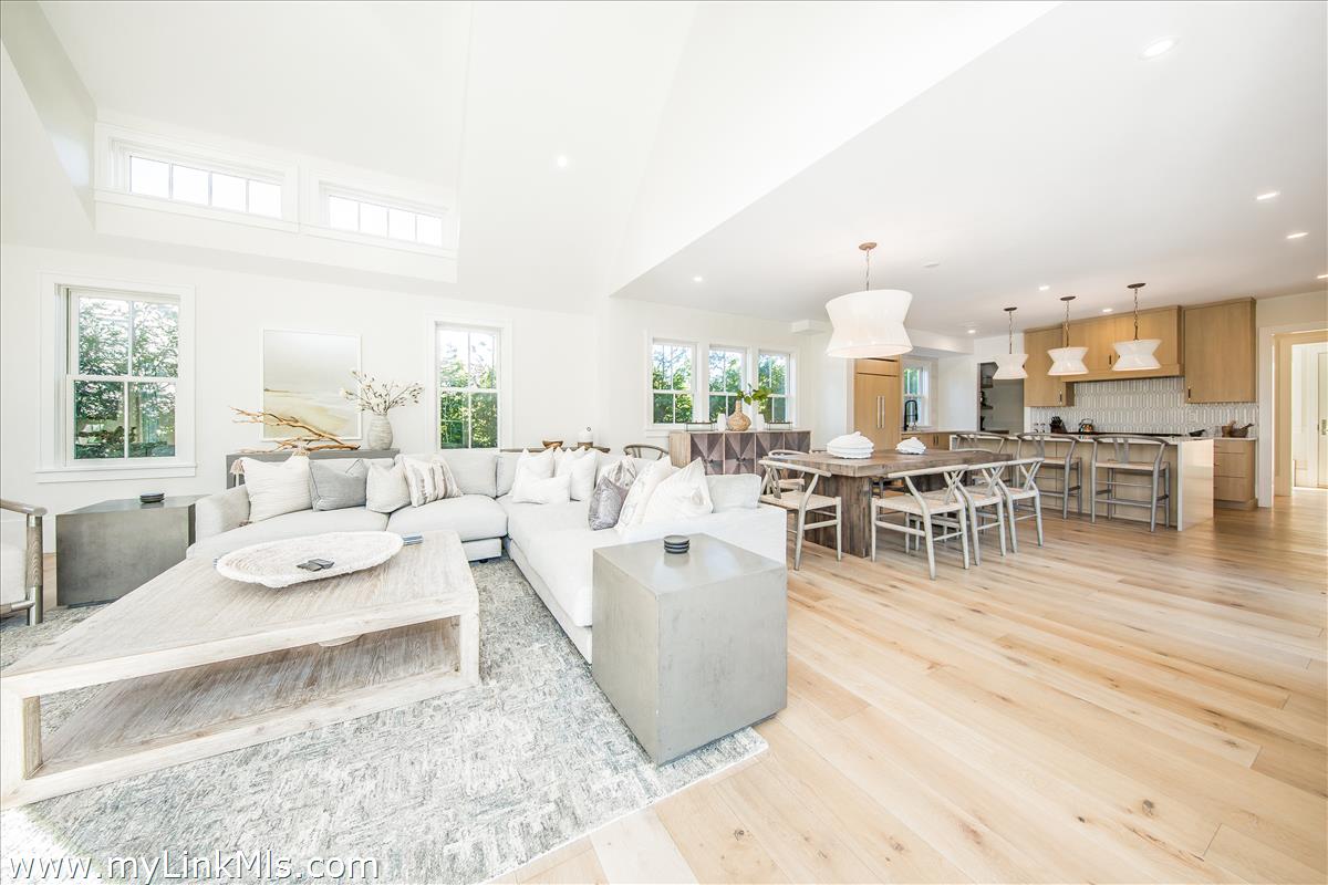 9 A Pilgrim Road Nantucket, MA 02554 - Photo 11 of 34 a living room with furniture and a dining table with wooden floor