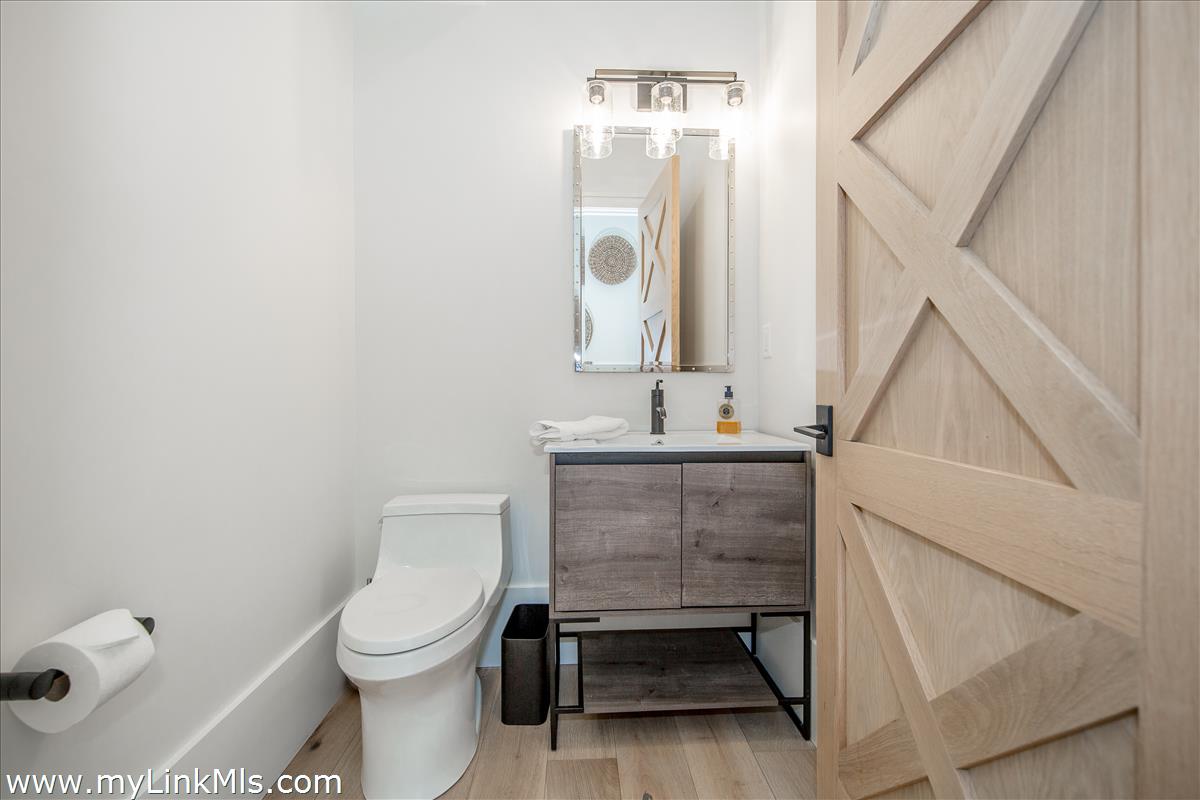 9 A Pilgrim Road Nantucket, MA 02554 - Photo 17 of 34 a bathroom with a toilet sink and mirror