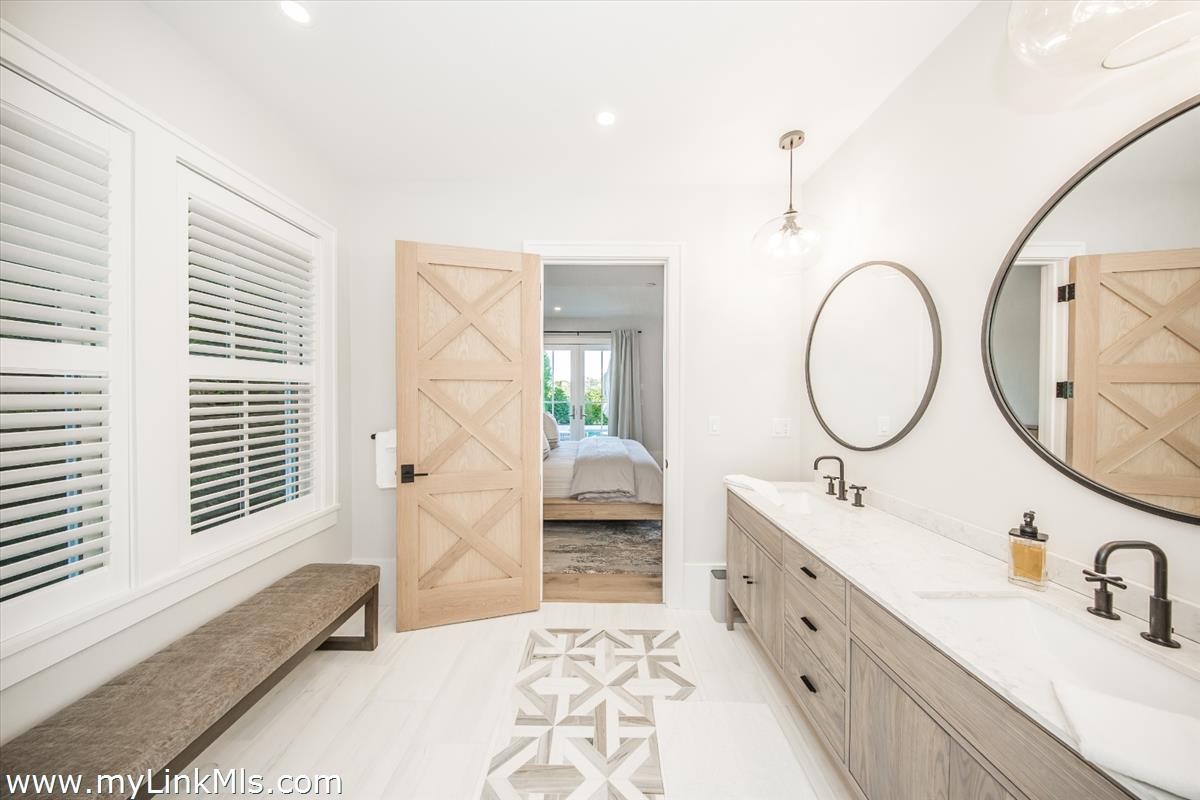 9 A Pilgrim Road Nantucket, MA 02554 - Photo 19 of 34 a spacious bathroom with a double vanity sink a mirror and a bathtub