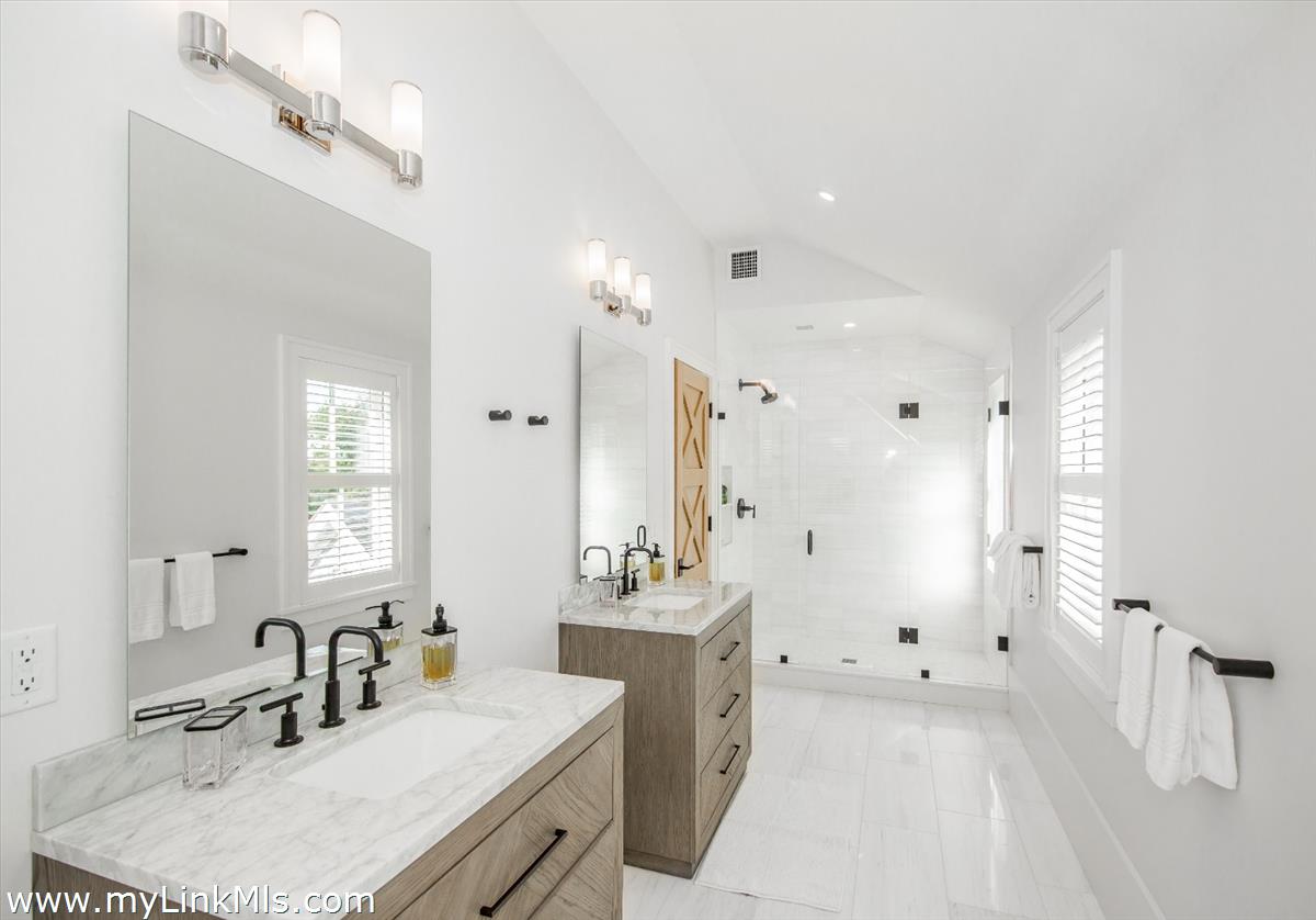 9 A Pilgrim Road Nantucket, MA 02554 - Photo 23 of 34 a bathroom with a sink double vanity granite tub shower and a mirror