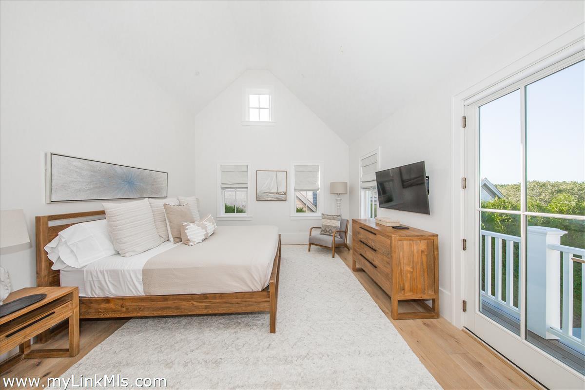 9 A Pilgrim Road Nantucket, MA 02554 - Photo 26 of 34 a bedroom with a bed and a flat screen tv