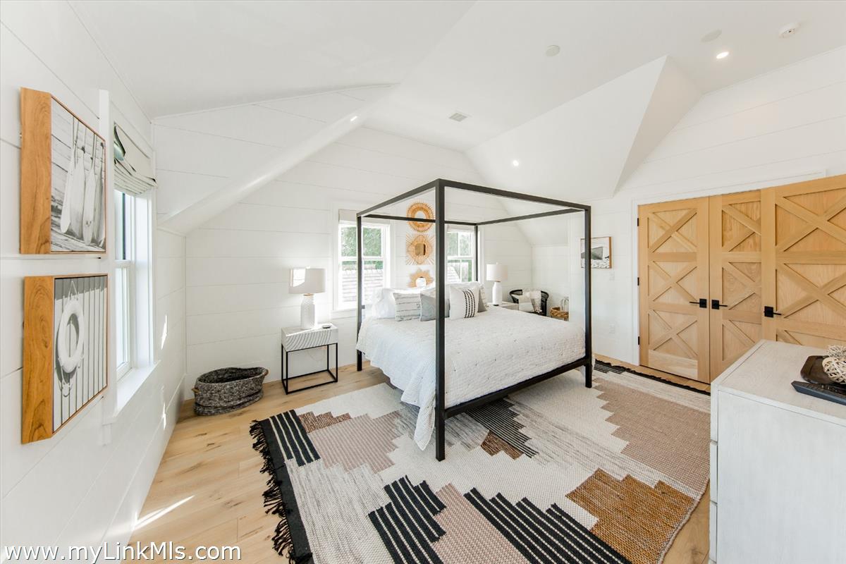 9 A Pilgrim Road Nantucket, MA 02554 - Photo 29 of 34 a bedroom with a bed and a large mirror