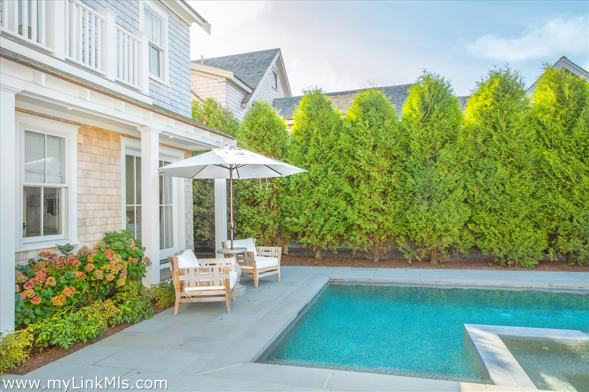 9 A Pilgrim Road Nantucket, MA 02554 - Photo 3 of 34 a view of a patio with table and chairs potted plants and floor to ceiling window