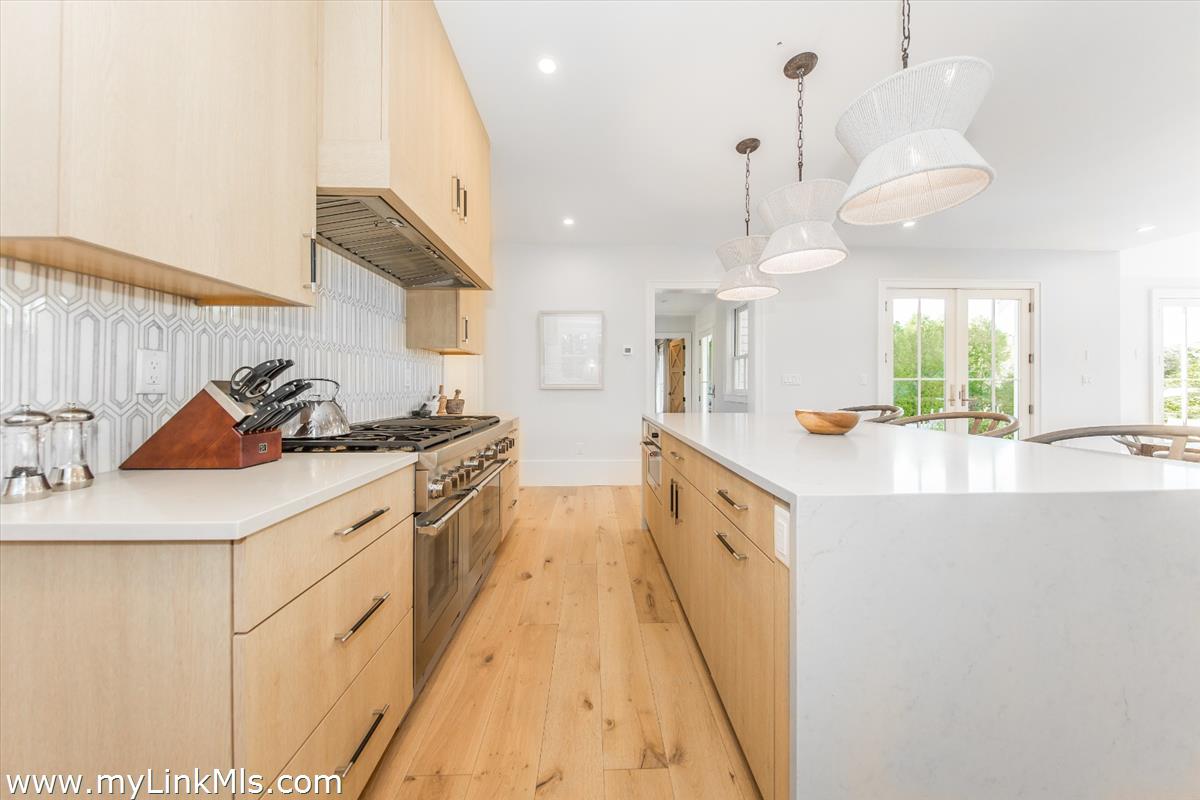 9 A Pilgrim Road Nantucket, MA 02554 - Photo 10 of 34 a large kitchen with granite countertop a sink a stove and a refrigerator