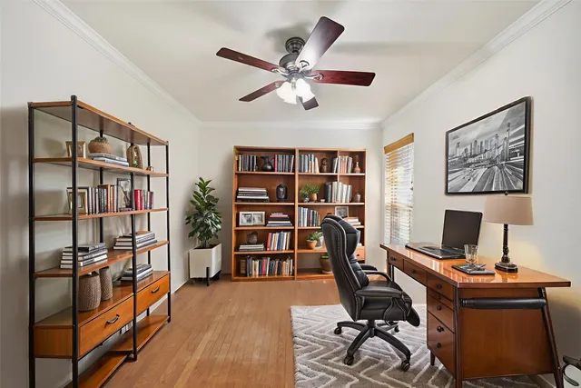 a view of a workspace with furniture and a bookshelf