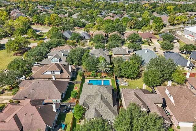an aerial view of multiple houses with yard