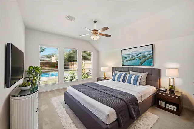 a spacious bedroom with a large bed and a flat screen tv