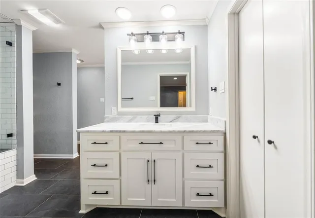 a bathroom with a glass shower door