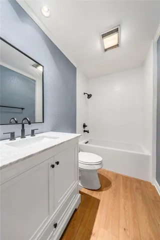 a spacious bathroom with a sink and a mirror