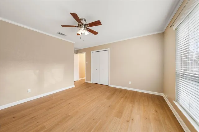 a view of a room with wooden floor and brick walls