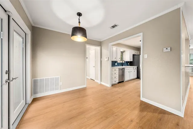 a kitchen with granite countertop a refrigerator sink and cabinets