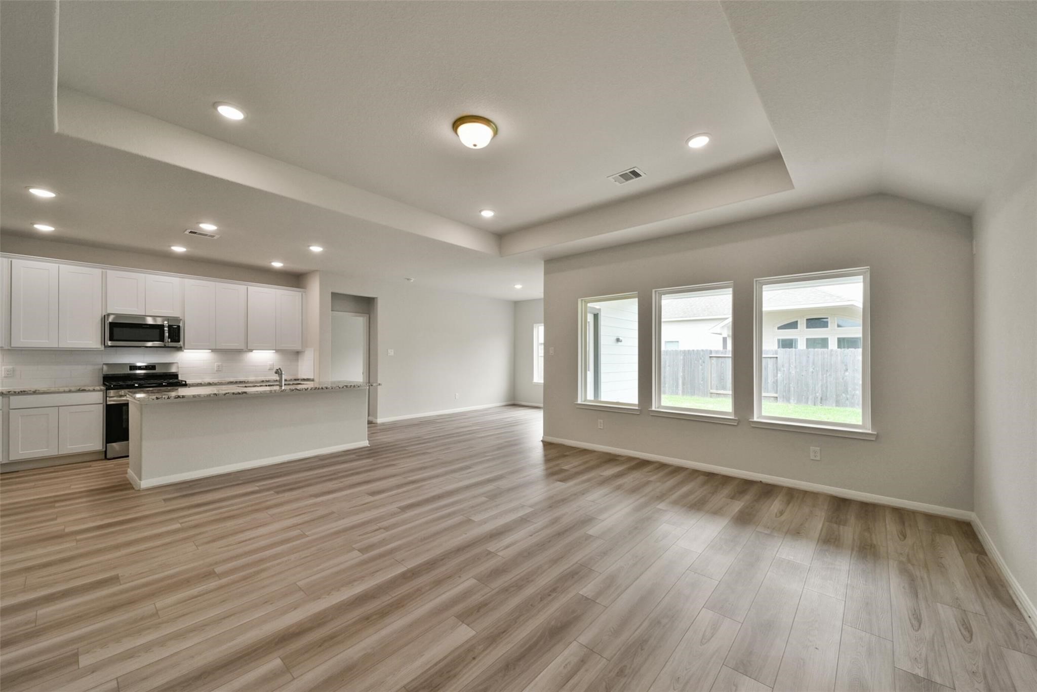 10522 Plumas Run Drive Rosharon, TX 77583 - Photo 6 of 29 Bright, open-concept living space featuring a gourmet granite kitchen and modern wood flooring.