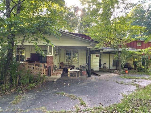 275 Pine Top Road Toone, TN 38381 - Photo 3 of 10 a view of a patio with table and chairs and wooden fence