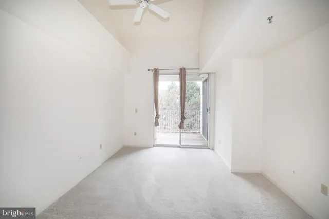 a view of an empty room with glass door