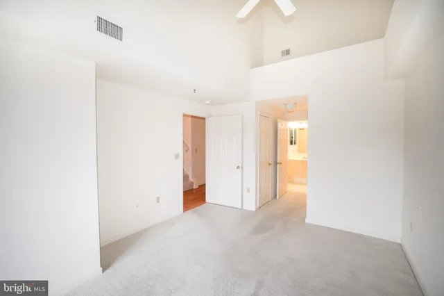 a view of a room with wooden floor and white walls