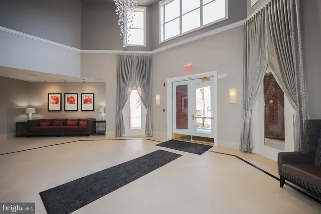 a large bedroom with a bed and a large mirror