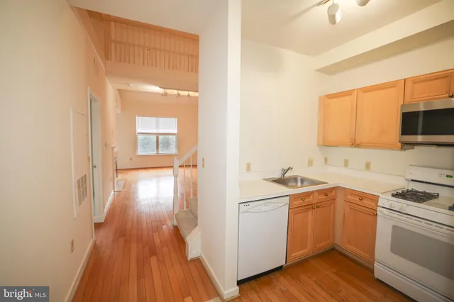 a kitchen with a sink stove and refrigerator