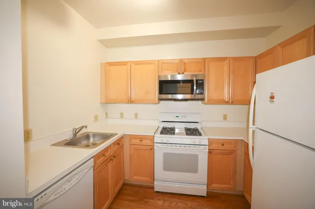 a kitchen with a refrigerator sink and microwave