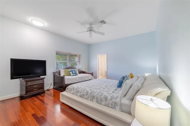 a bedroom with bed and a flat screen tv