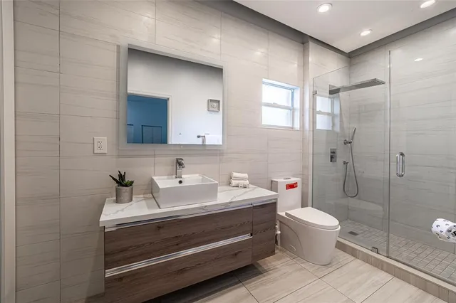 a bathroom with a sink toilet and shower