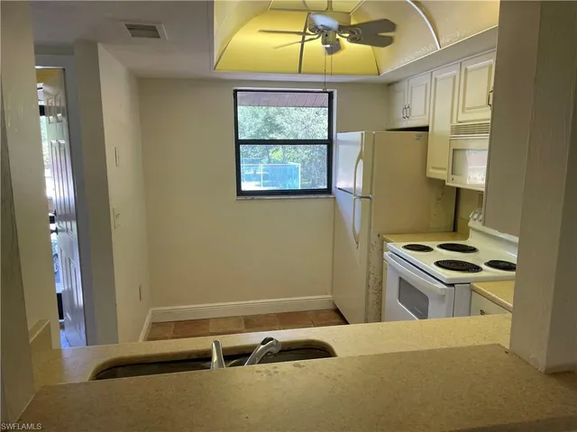 a kitchen that has a stove and a window
