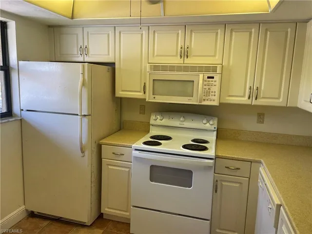 a kitchen with a refrigerator stove and microwave