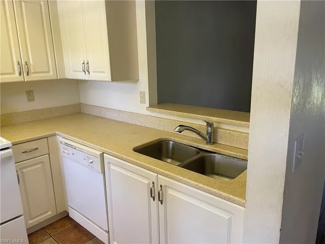 a view of a kitchen with white cabinets