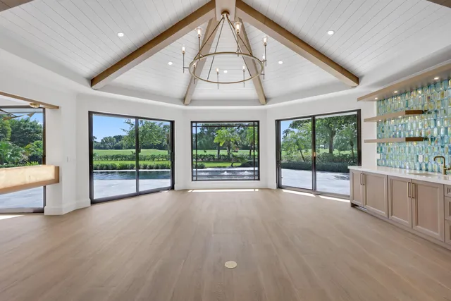 a kitchen with stainless steel appliances granite countertop a sink and a large window
