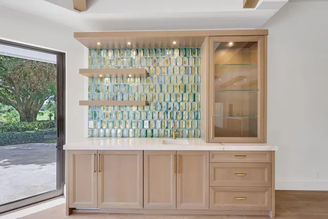 a view of a big room with wooden floor and windows