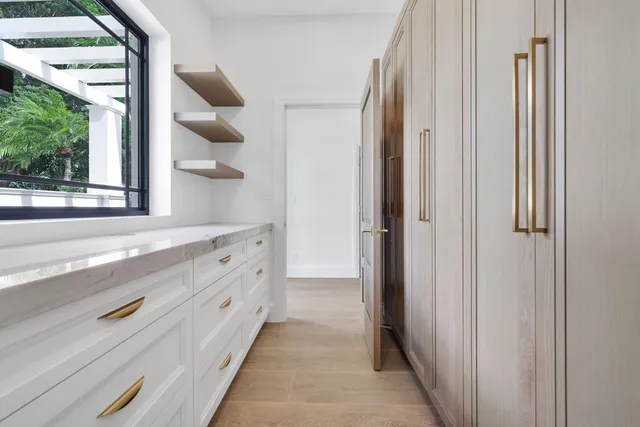 a large bathroom with a double vanity sink a large mirror and a shower