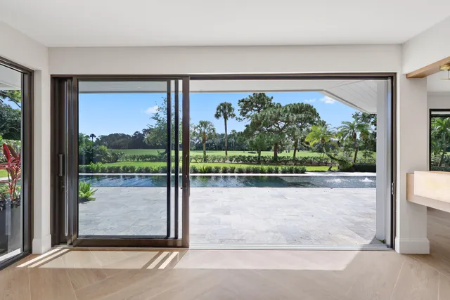 a bathroom with a granite countertop sink a toilet a mirror and bathtub